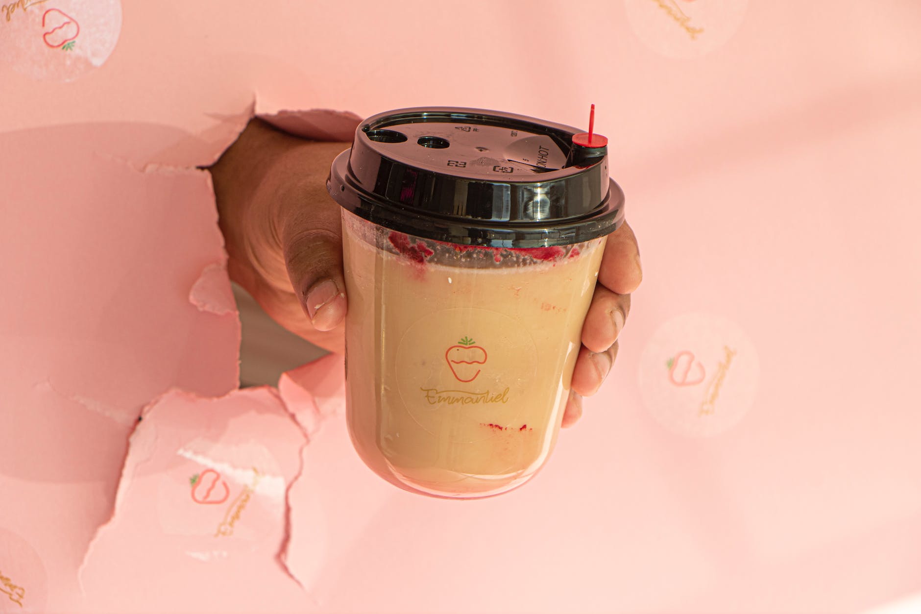 hand holding a cup with a shake